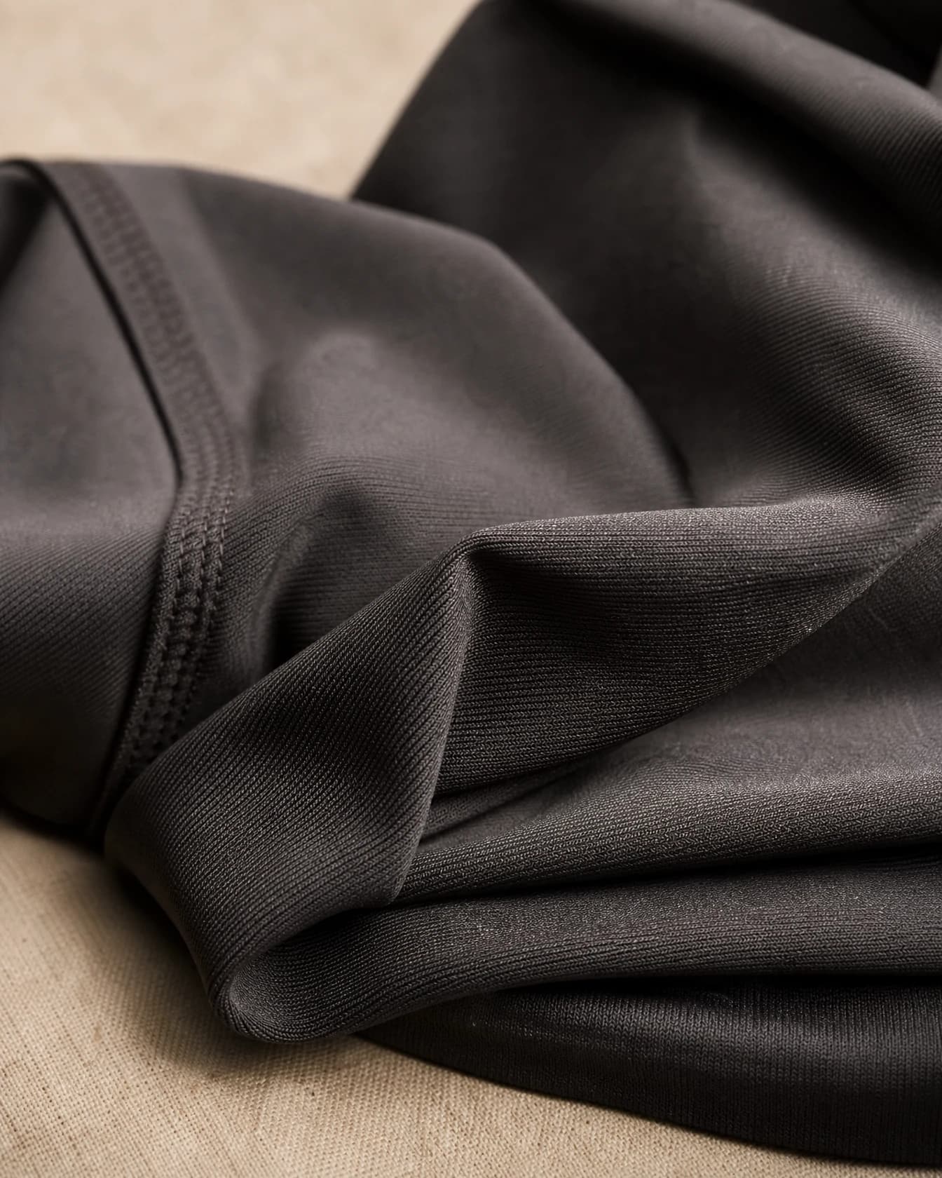 Folded stretch performance fabric showing a subtle sheen
