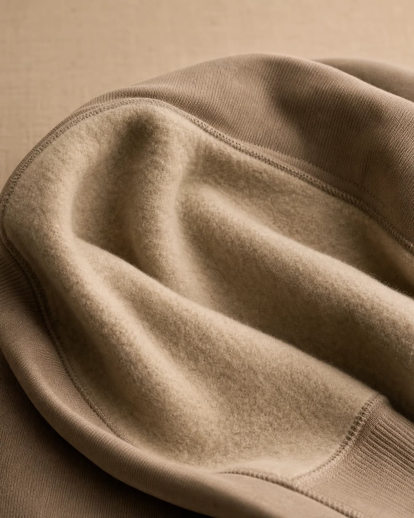 The brushed fleece interior of a hoodie folded open